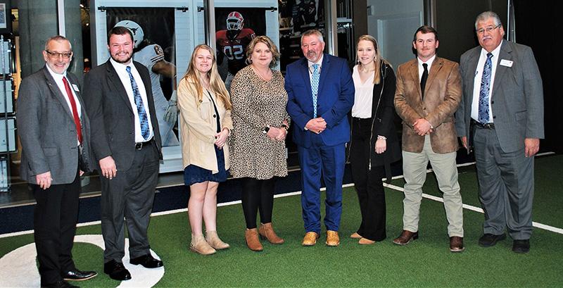 From left, UGA Extension Assistant Dean Mark McCann joins Justin Pate, Christian Pate, Scotty Raines, Melanie Raines, Celie Raines, Guy Hancock and CAES Dean Nick Place at a celebration announcing Scotty Raines' selection as 2022 Georgia Farmer of the Year during the annual meeting of the Georgia Agribusiness Council. (Photo by University of Georgia)